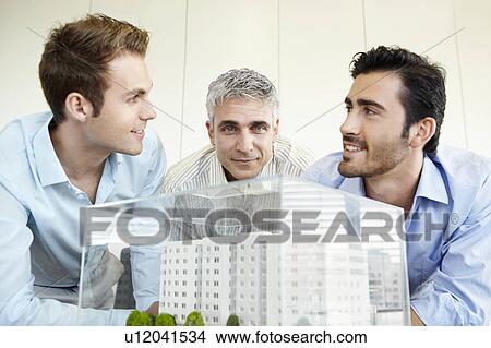3 men discussing architectural model View Large Photo Image Picture - 3 men discussing architectural model. Fotosearch