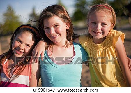 3 smiling young girls hugging View Large Photo Image Stock Photo - 3 smiling young girls hugging. Fotosearch