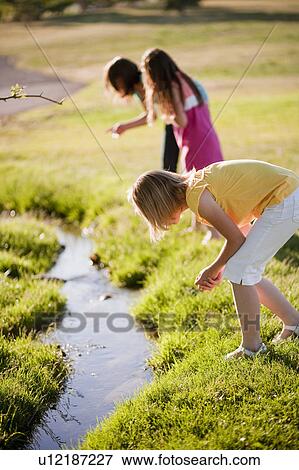 3 young girls looking in creek View Large Photo Image Stock Photo - 3 young girls looking in creek. Fotosearch