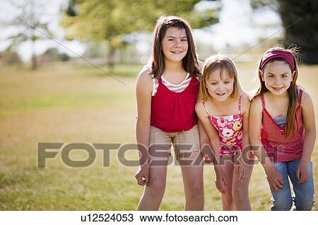 3 young girls standing in line laughing View Large Photo Image Stock Image - 3 young girls standing in line laughing. Fotosearch