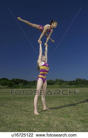 Acrobatic troop performing moves View Large Photo Image Stock Image - Acrobatic troop performing moves. Fotosearch