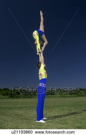 Stock Image - Acrobatic troop performing moves. Fotosearch