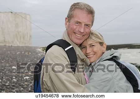 Active seniors embrace on beach View Large Photo Image Stock Photo - Active seniors embrace on beach. Fotosearch