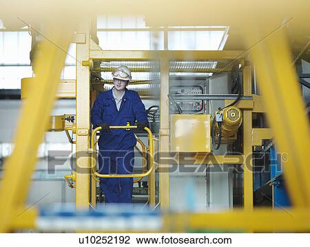 Stock Image - Apprentice engineer in Charging Hall. Fotosearch