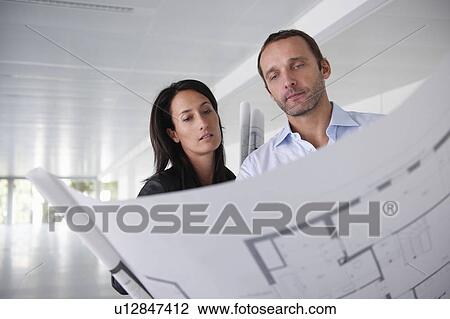Architects looking at blue prints View Large Photo Image Stock Image - Architects looking at blue prints. Fotosearch