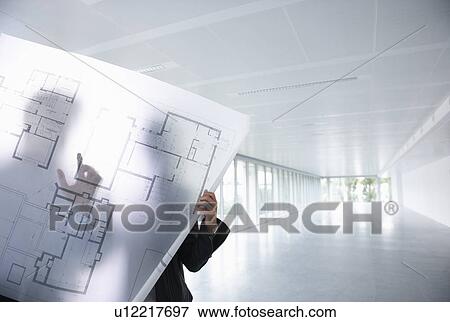 Stock Photo - Architects looking at blue prints. Fotosearch