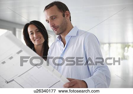 Architects looking at blue prints View Large Photo Image Stock Photo - Architects looking at blue prints. Fotosearch
