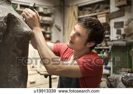 Artist working on sculpture View Large Photo Image Stock Photo - Artist working on sculpture. Fotosearch