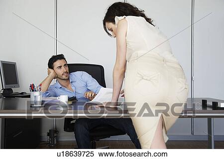 Stock Photography - Attractive woman and male colleague. Fotosearch