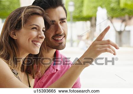 Stock Photography - Attractive young couple in city square. Fotosearch