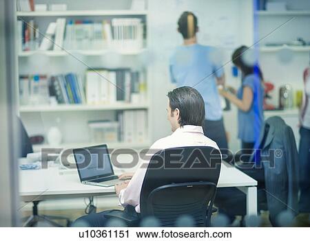 Back of businessman through window View Large Photo Image Stock Image - Back of businessman through window. Fotosearch