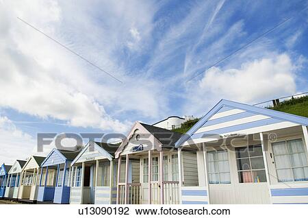 Beach huts under blue sky View Large Photo Image Stock Image - Beach huts under blue sky. Fotosearch