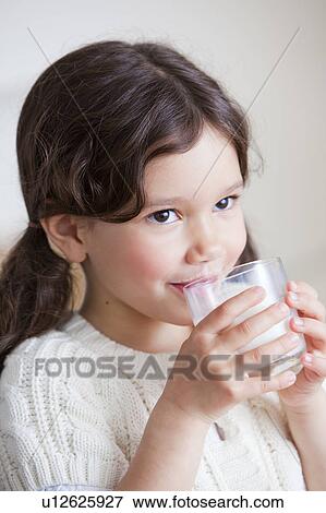 Stock Photo - Beautiful young girl drinking milk. Fotosearch