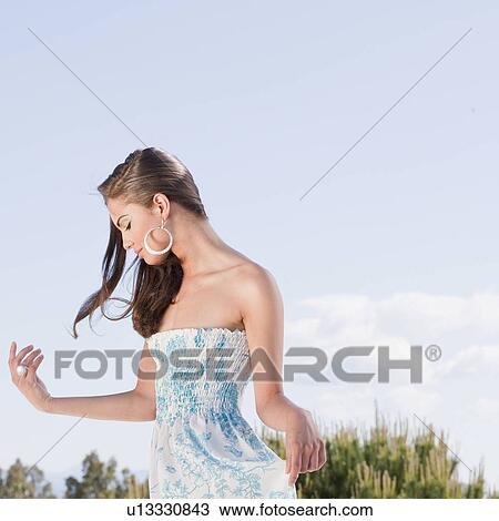 Beautiful young woman in flowery dress View Large Photo Image Stock Image - Beautiful young woman in flowery dress. Fotosearch