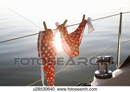 Stock Image - Bikini hanging on rail. Fotosearch