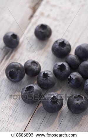 Blueberries sitting on a wooden table View Large Photo Image Stock Image - Blueberries sitting on a wooden table. Fotosearch