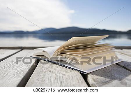 Book on jetty by sea and mountains View Large Photo Image Stock Photography - Book on jetty by sea and mountains. Fotosearch