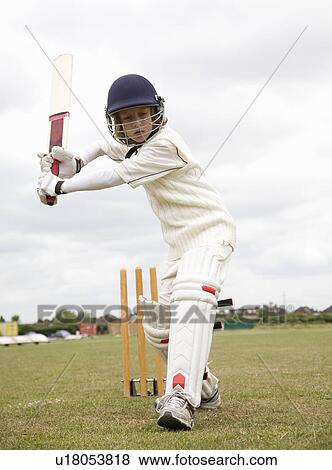 Stock Photo - Boy (10-12) playing cricket. Fotosearch