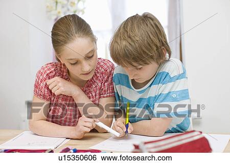 Stock Photograph - Boy and girl doing homework. Fotosearch