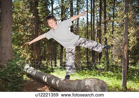 Boy balancing on log View Large Photo Image Stock Photo - Boy balancing on log. Fotosearch