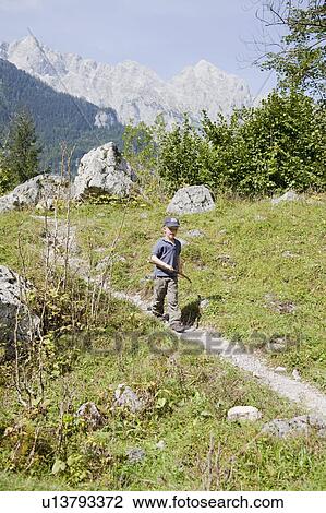 Boy coming down a hill View Large Photo Image Stock Image - Boy coming down a hill. Fotosearch