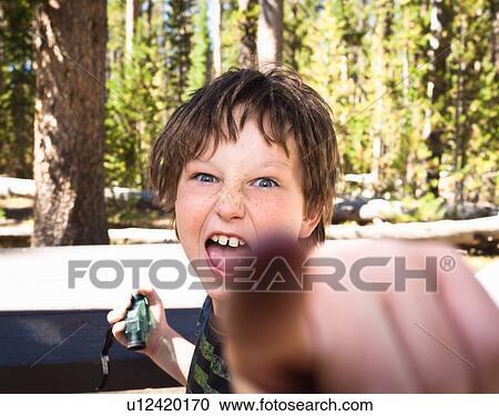 Stock Image - Boy confronting camera. Fotosearch