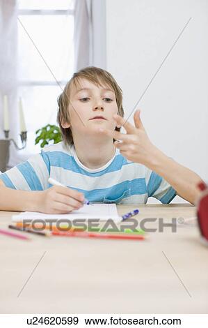 Boy doing his homework View Large Photo Image Stock Photo - Boy doing his homework. Fotosearch