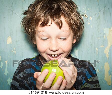 Boy holding apple View Large Photo Image Stock Photograph - Boy holding apple. Fotosearch