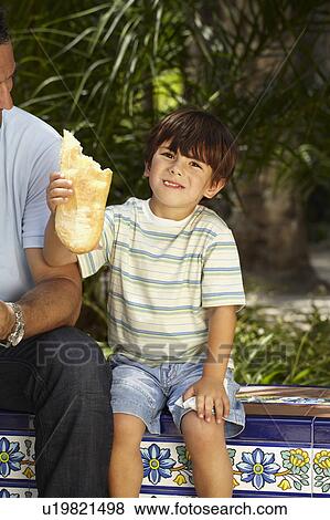 Boy holding piece of bread View Large Photo Image Stock Photo - Boy holding piece of bread. Fotosearch