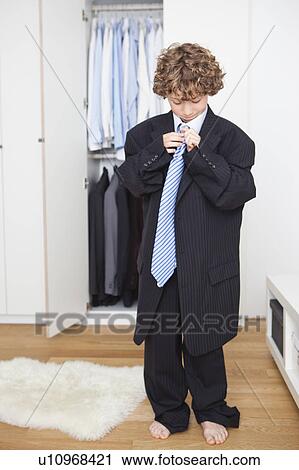 Boy in fathers suit View Large Photo Image Stock Image - Boy in fathers suit. Fotosearch