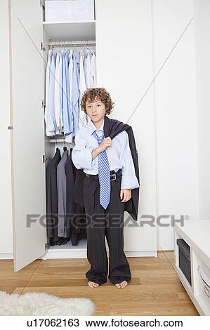 Boy in fathers suit View Large Photo Image Stock Image - Boy in fathers suit. Fotosearch