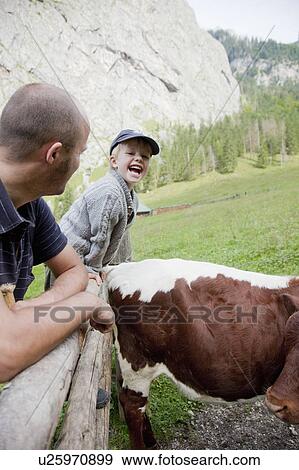 Boy laughing besides a field View Large Photo Image Stock Photo - Boy laughing besides a field. Fotosearch