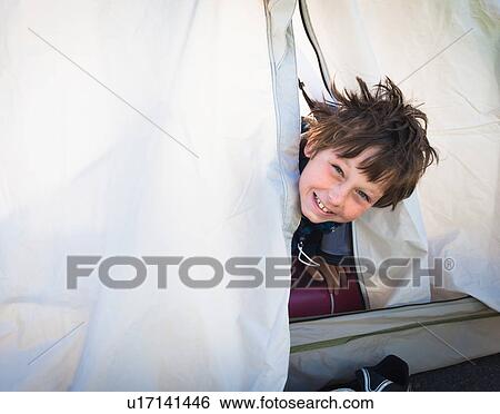 Boy looking out of tent View Large Photo Image Stock Photograph - Boy looking out of tent. Fotosearch