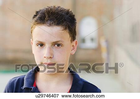 Stock Photo - Boy looking to the camera on a sunny day. Fotosearch