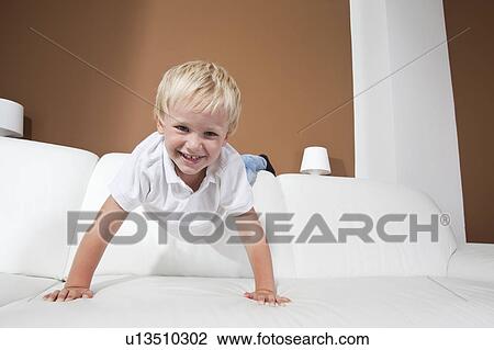 Boy on couch View Large Photo Image Stock Image - Boy on couch. Fotosearch