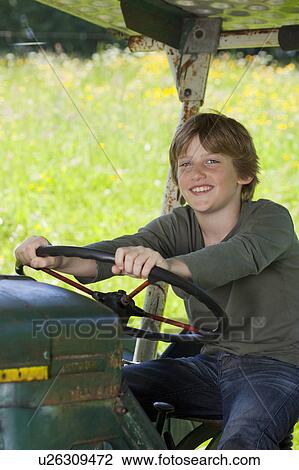 Stock Image - Boy on truck, proud. Fotosearch
