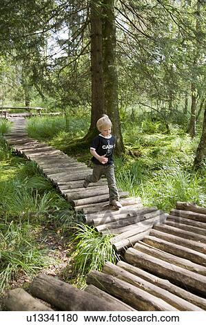 Boy running on a footbridge View Large Photo Image Stock Image - Boy running on a footbridge. Fotosearch