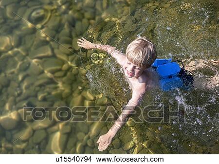 Boy swimming with swimming belt View Large Photo Image Picture - Boy swimming with swimming belt. Fotosearch