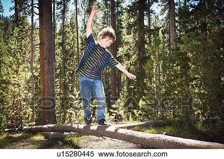 Boy walking across log View Large Photo Image Stock Photography - Boy walking across log. Fotosearch