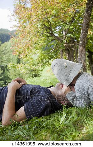 Stock Photography - Boy with hat cuddling his father. Fotosearch