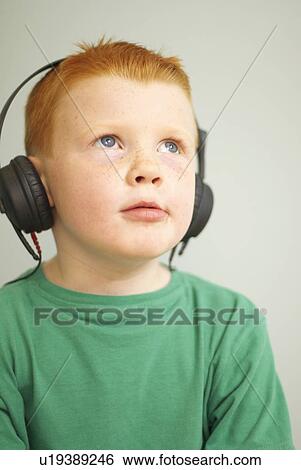 Stock Photograph - Boy with headphones on. Fotosearch