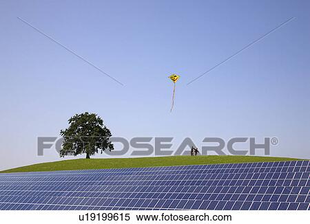 Boys flying kite at solar power station View Large Photo Image Stock Photography - Boys flying kite at solar power station. Fotosearch