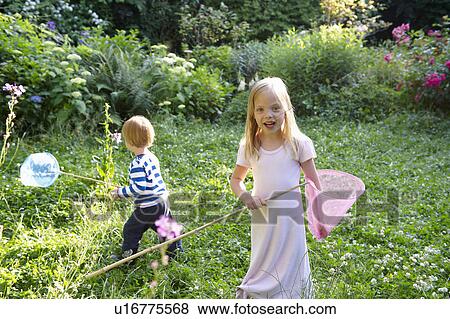 Brother and sister with butterfly nets View Large Photo Image Stock Photo - Brother and sister with butterfly nets. Fotosearch