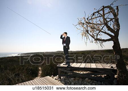 Business man in barren landscape View Large Photo Image Stock Image - Business man in barren landscape. Fotosearch