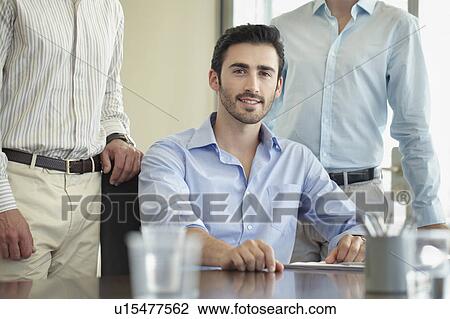 Business man sitting at table View Large Photo Image Stock Image - Business man sitting at table. Fotosearch