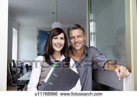 Stock Photograph - Business partners smiling to camera. Fotosearch