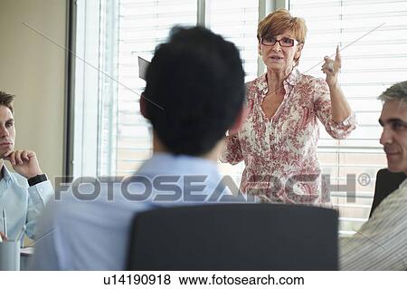 Stock Photo - Business people in discussion at meeting. Fotosearch