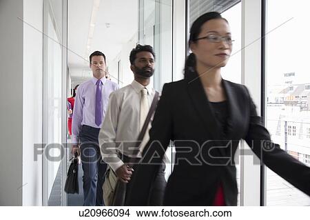 Picture - Business people rushing past camera. Fotosearch