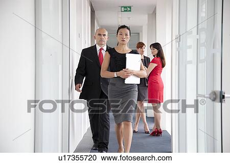 Business people walking down corridor View Large Photo Image Stock Image - Business people walking down corridor. Fotosearch