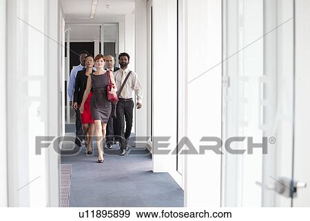 Stock Photo - Business people walking down corridor. Fotosearch